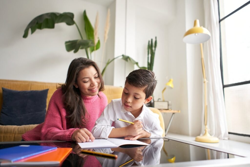 Mother helping her son to do homework for school