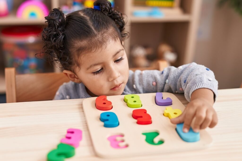 Small girl playing with number recognition