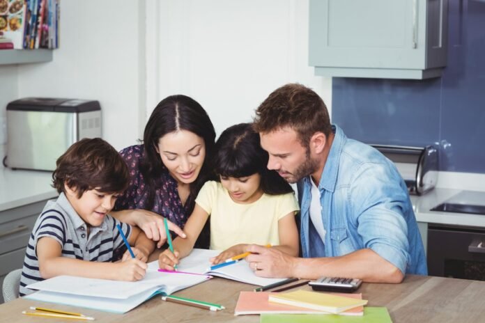 Parents helping children in doing homework at home Helping Kids with Homework strategies that works